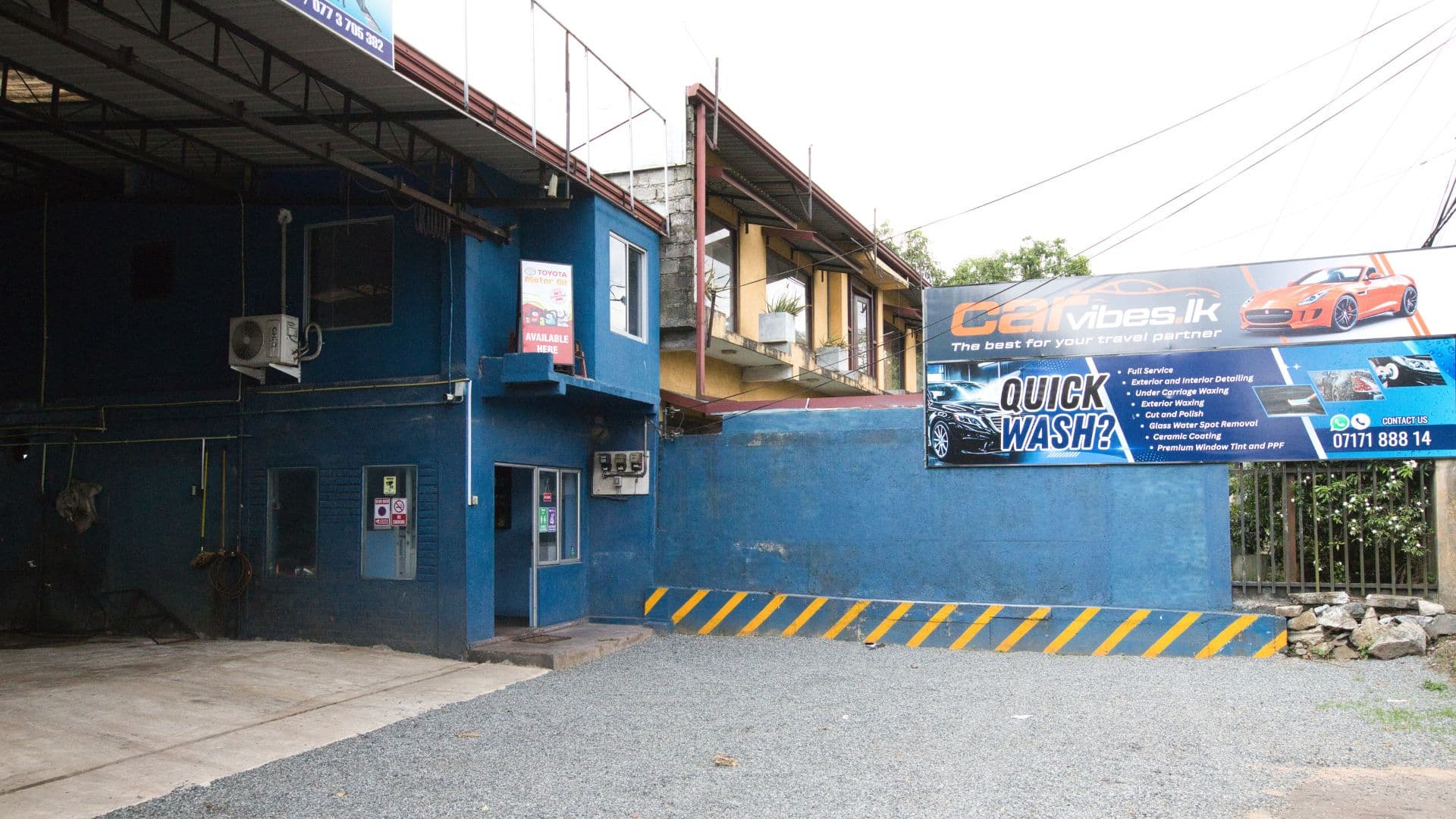 CarVibes  facility exterior featuring official branded billboard, service menu, and reception
